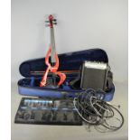 An Edenstar electric violin together with a Boss me-6 effects pedal and a Castle AG10M amplifier