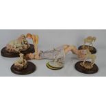Four Fables unicorn figurines on wooden plinths together with a Grant Palmers views of life figure