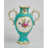 An 18th century Chelsea Derby turquoise vase, with painted floral panels, circa 1775. 18cms