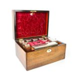 A Victorian rosewood dressing table box, fitted with five silver plated bottle and four glass top