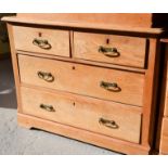 An antique pine chest of drawers, two over two long drawers, with brass fittings. 77cmh x 102cm wide