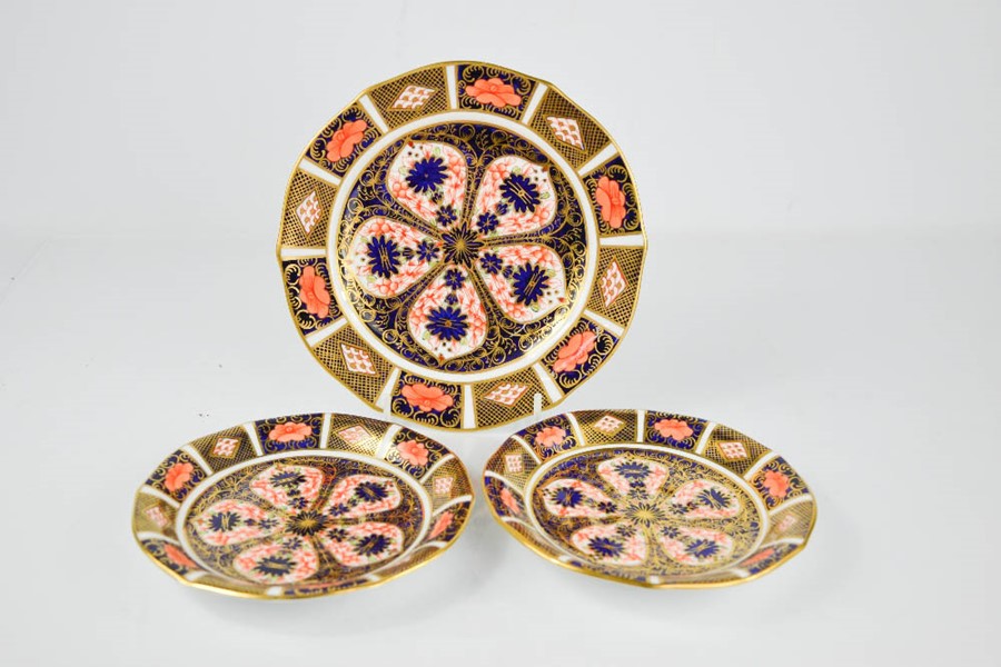 Two Royal Crown Derby plates, circa 1930, 14cm diameter and a larger Royal Crown Derby plate 18cm