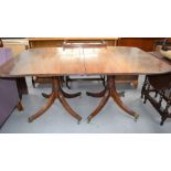 A 20th century twin pedestal dining table, in the Regency style, with reeded edge top and two