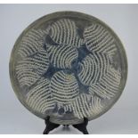 A hand carved stone bowl with fish decoration