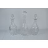 Three cut glass decanters, one pair and a single example.
