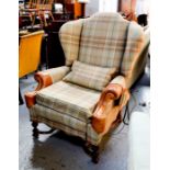 A tweed upholstered bespoke made electric reclining wingback armchair.