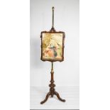 A 19th century polescreen, with a tapestry panel raised on a height adjustable brass pole.