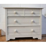 A small white painted pine chest of drawers.