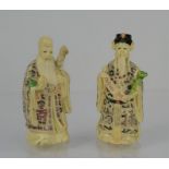 A pair of Chinese hand-painted resin figures Emperor and Empress - 10cms