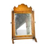 A Georgian mahogany toilet mirror, with shaped top and the original mirror with carved and gilded