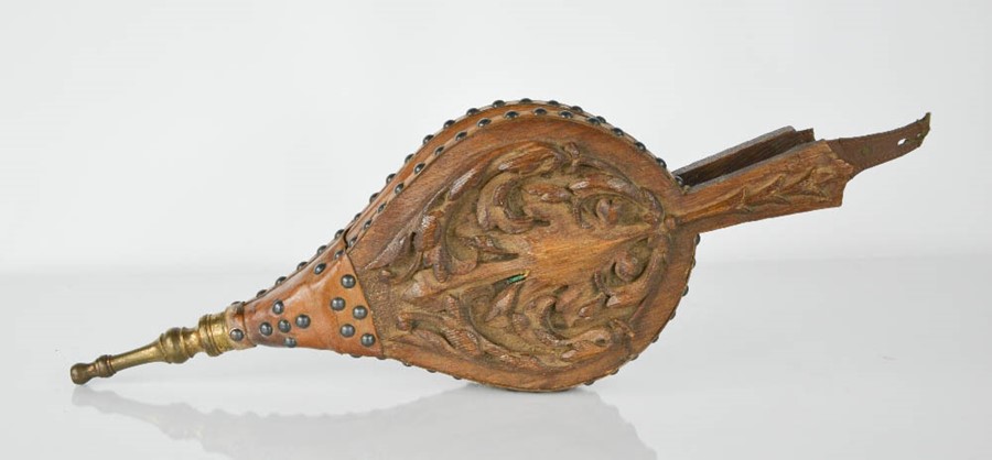 A pair of oak and leather bellows, carved with scrollwork, 50cm long.