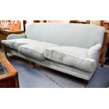 A pale upholstered duck egg blue three seater settee, in the Howard style.