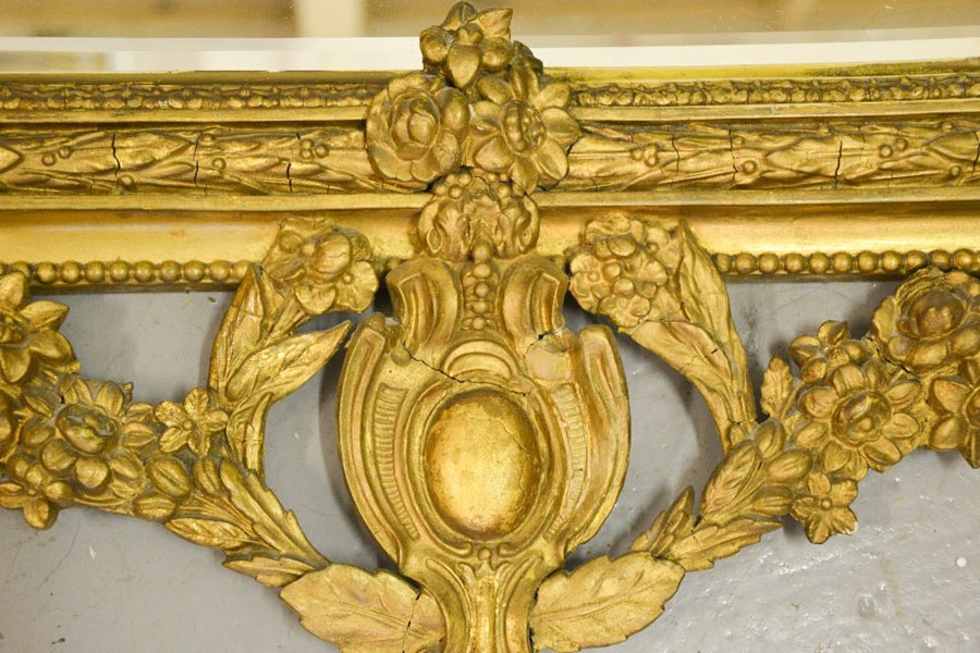 A 19th century ornate gilded mirror, modelled with a cherub beneath floral garlands to the top, - Image 3 of 3