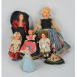 A group of vintage foreign collectible dolls together with a wind-up example