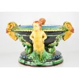 A 20th century majolica jardinere with cherub head handles interspersed with rams heads,.
