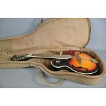 A Harley Benton HB 100 mandolin in a soft case.