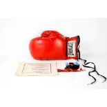 A boxing glove signed by Muhammad Ali, together with certificate of authenticity and photograph of
