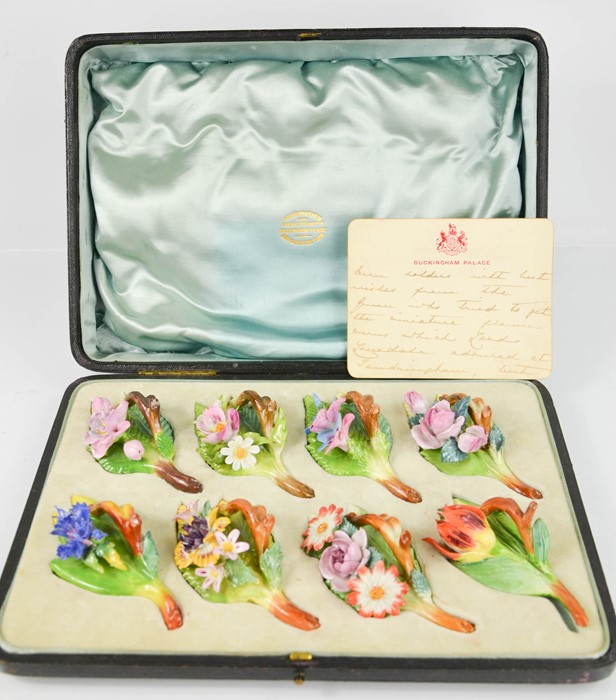 A fine set of Dresden floral table menu holders, modelled as different flowers, in the original