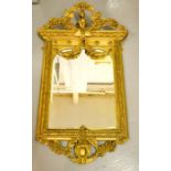 A 19th century ornate gilded mirror, modelled with a cherub beneath floral garlands to the top,