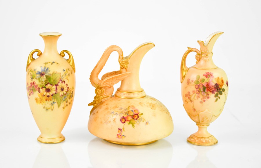 Three examples of miniature Royal Worcester; two ewers and a vase, each painted with flowers,