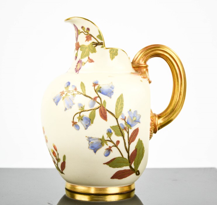 A Royal Worcester flat back jug hand painted with flowers, numbered 1888, with gilded handle and