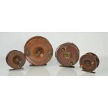 Four antique wood and brass centrepin fishing reels
