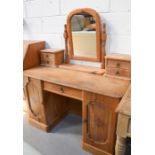 An antique pine dressing table, with two cupboard doors enclosing inner drawers. 75cm high x 121cm