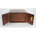 A wooden 14 drawer coin storage cabinet