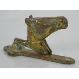 A vintage horse head brass door knocker