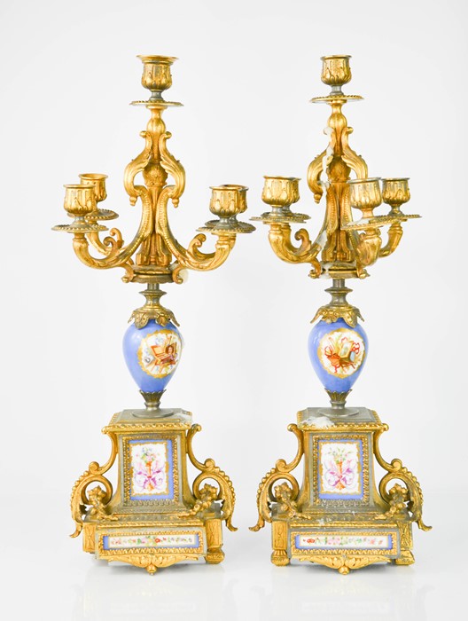 A pair of 19th century French five branch candelabras, with porcelain panels and porcelain bodies