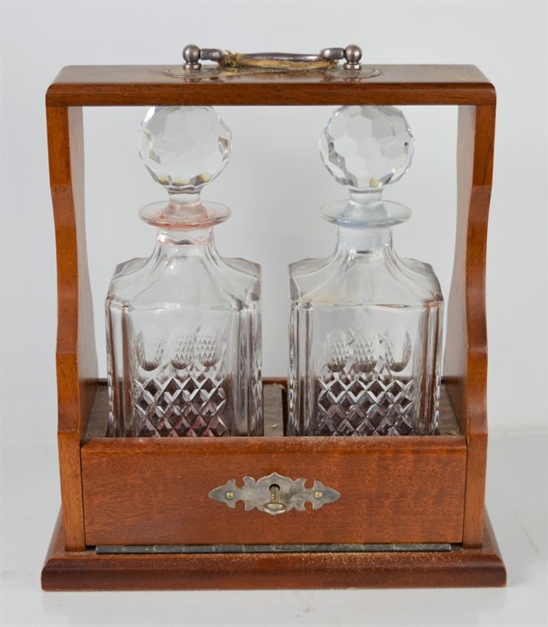 A Mahogany Tantalus with two decanters