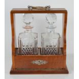 A Mahogany Tantalus with two decanters