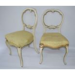 A pair of white painted balloon back chairs with upholstered seats.