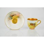 A Royal Worcester up and saucer, painted with a Woodcock, signed J Smith, the saucer painted with