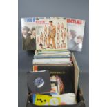 A quantity of LP's and singles to include - Abba , Elvis Presley , Beatles, Madonna , Pink Floyd ,