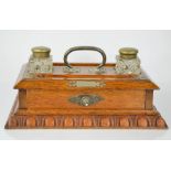 A 19th century oak desktop ink stand, with a pair of ink bottles with brass mounts and single