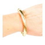 A 9ct gold bangle with clasp. 16.6g