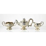 A Georgian silver tea set comprising teapot, slop bowl and milk jug, London 1816, embossed with