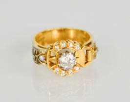 An 18ct gold buckle ring, centred by a diamond approximately 0.35cts and set with twelve further - Image 2 of 5