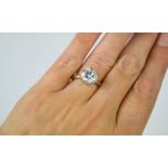 A solitaire ring stamped 750 and maker JN to the shank, Paste stone / crystal, size O/P,