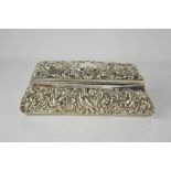 A Victorian silver dressing table box by William Comyns & Sons, embossed with scrollwork, flowers