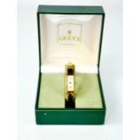 A Gucci 1500 gold plated quartz watch with mother of pearl dial