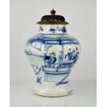 A Chinese Qing dynasty blue and white vase, with pierced wooden carved cover, 40cm high.