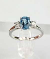 An 18ct white gold, aquamarine and diamond ring, the 1.20ct aquamarine flanked by 0.20cts diamonds - Image 6 of 7