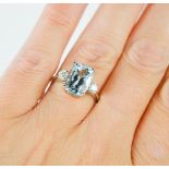 A platinum, aquamarine and diamond ring, the rectangular cushion cut aquamarine approximately 3.