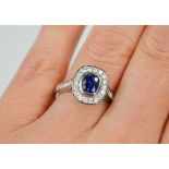 An 18ct white gold sapphire and diamond ring, the sapphire approximately 0.90ct, the diamodns