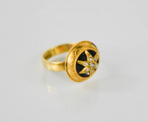 A 9ct antique yellow gold and diamond set star and enamel mourning ring, size N, 4.3g.