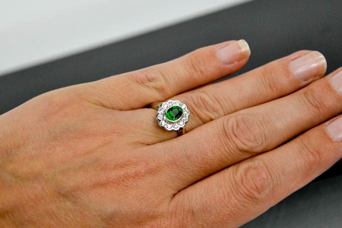 An 18ct white gold and tsavorite garnet and diamond ring, the tsavorite approximately 1.10ct, the