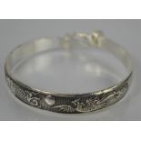 A Tibetan Miao silver extending dragon and phoenix bangle