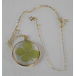 A gold [untested] clover leaf pendant and necklace